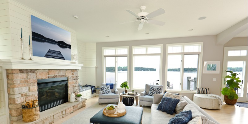 Ceiling fan in living room with fireplace